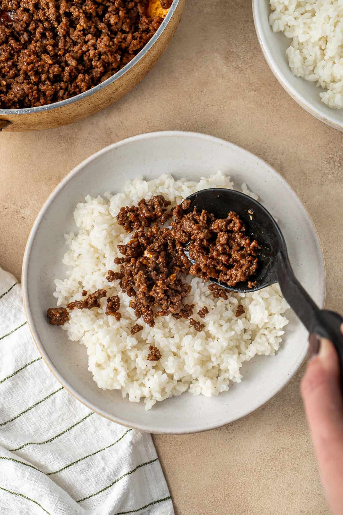 Adding the beef mince on top of the cooked rice.