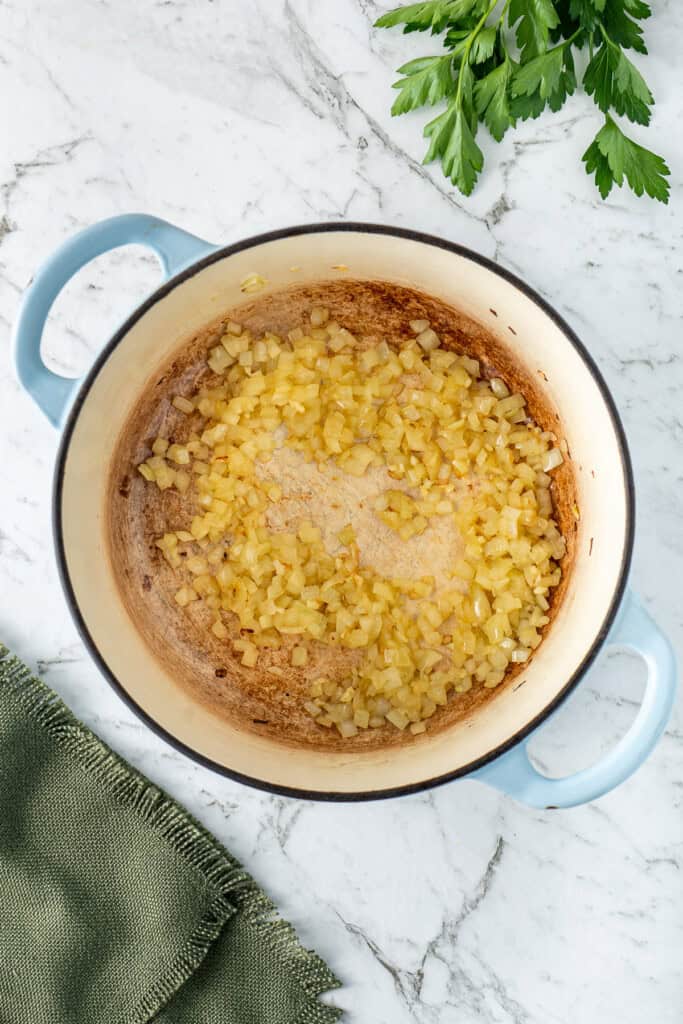Sautéing the onions and garlic in the pot.