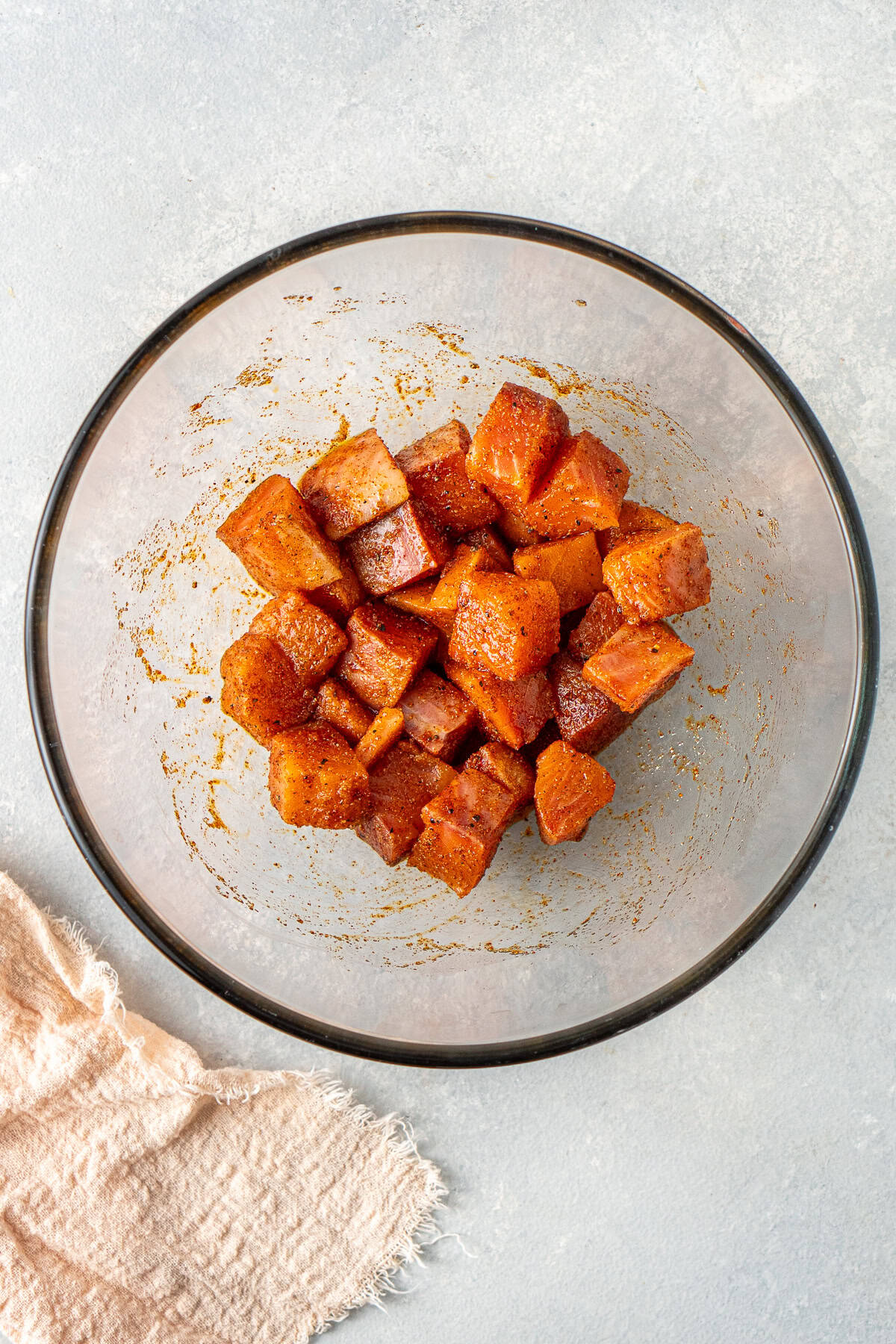 The cubed salmon tossed with the spices.