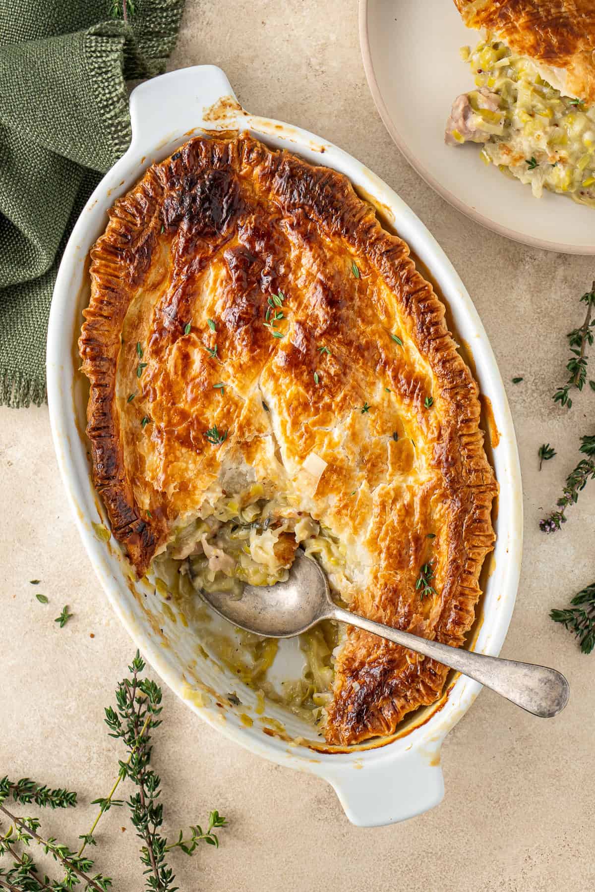 A spoon serving the chicken and leek pie.