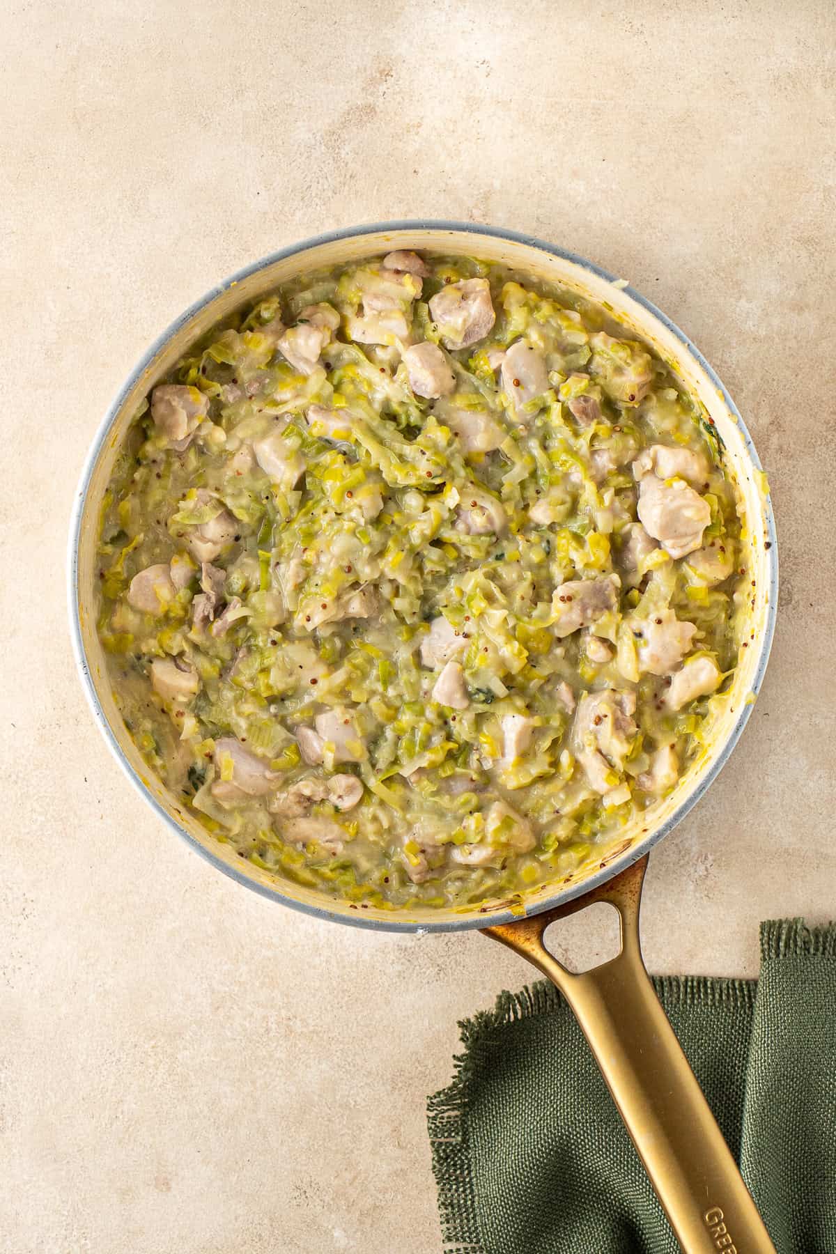 The cooked filling that is thick and creamy in a frying pan.