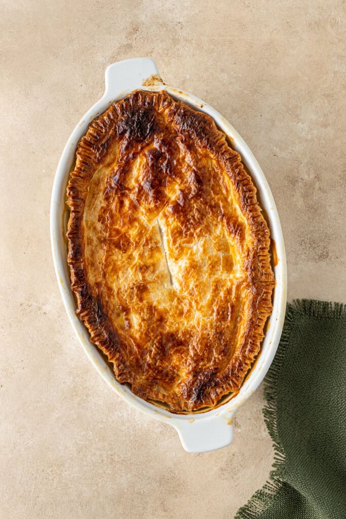 The freshly baked pie with golden pastry.