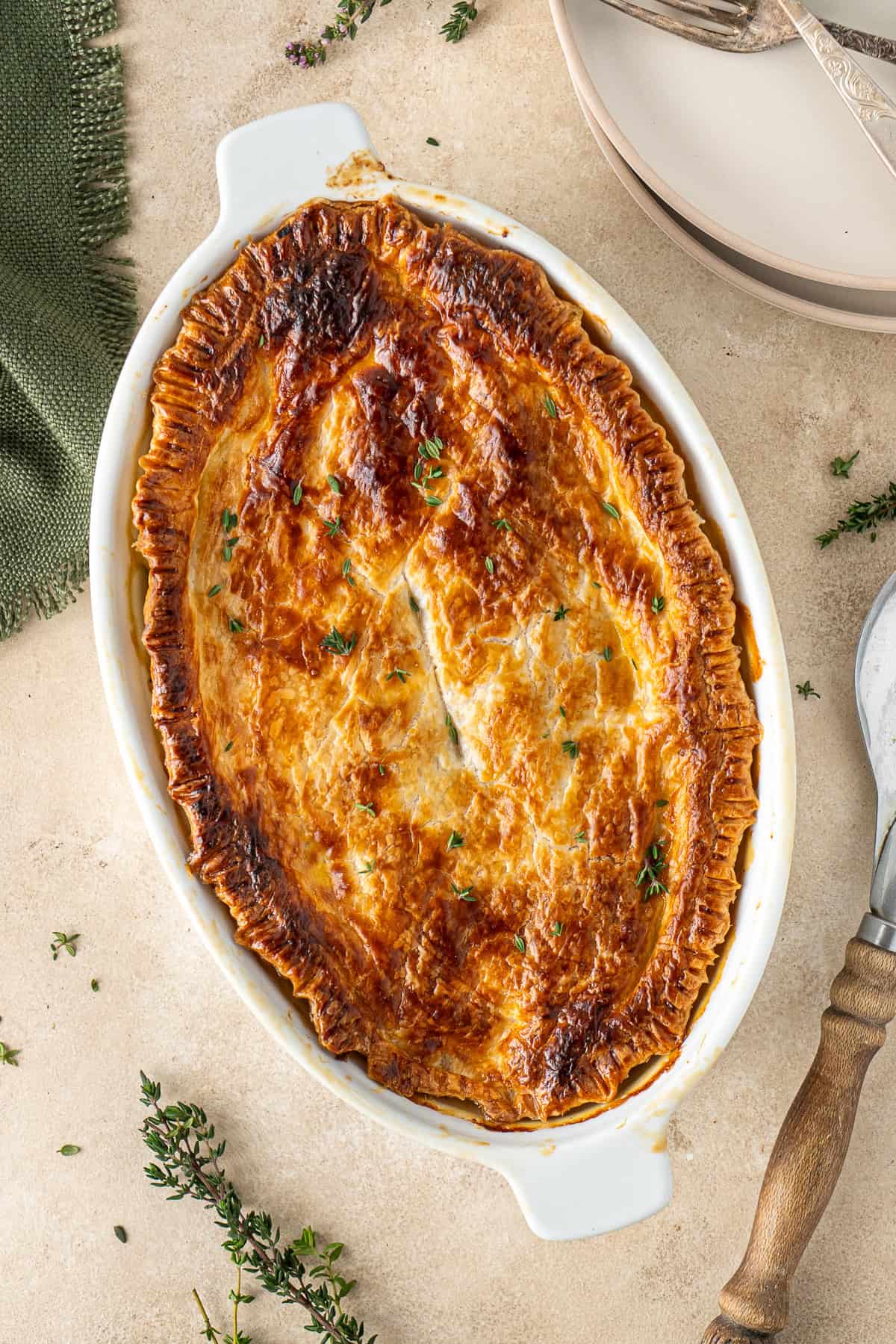 The baked chicken and leek pie in a pie dish with golden pastry.