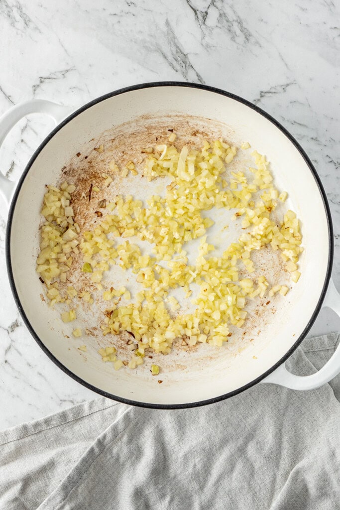 Cooking the onions and garlic in the pot.