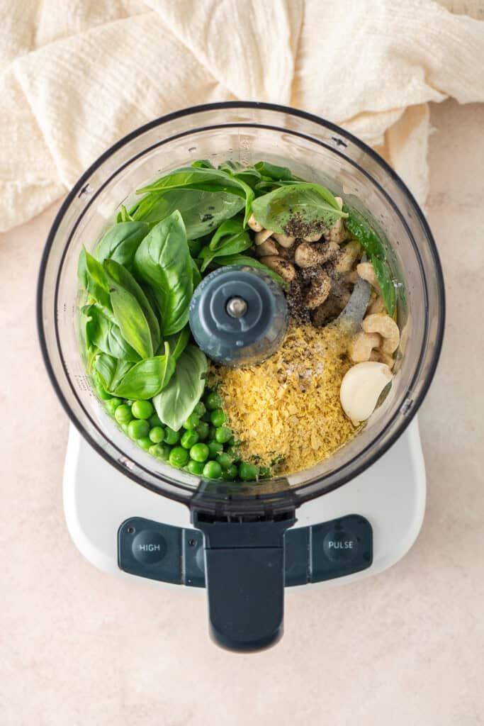 All pea pesto ingredients in a food processor.