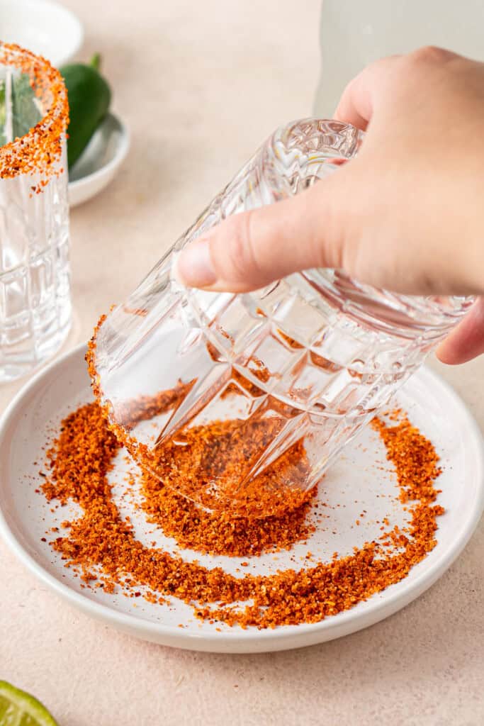 Dipping the glass in tajin for the rim.
