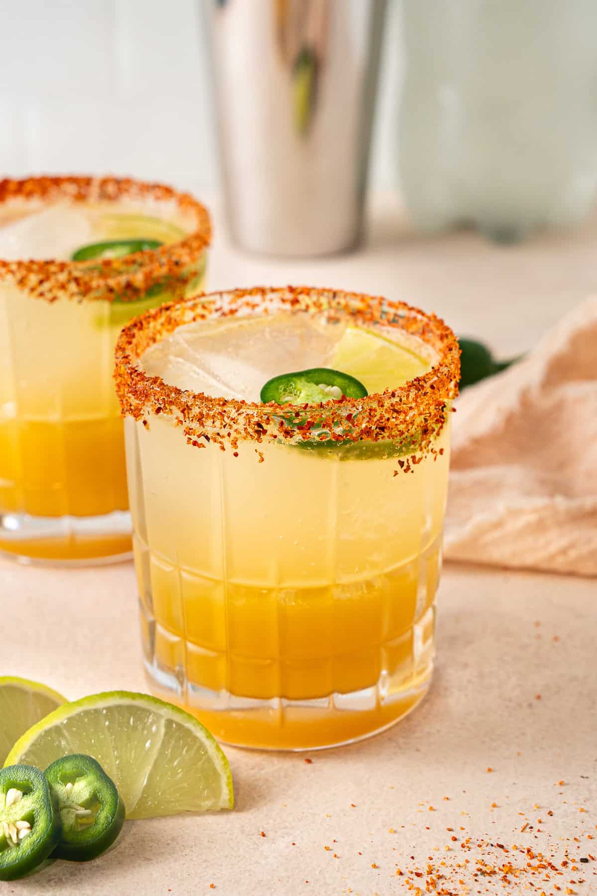Two spicy non alcoholic margaritas with fresh lime and jalapenos. 