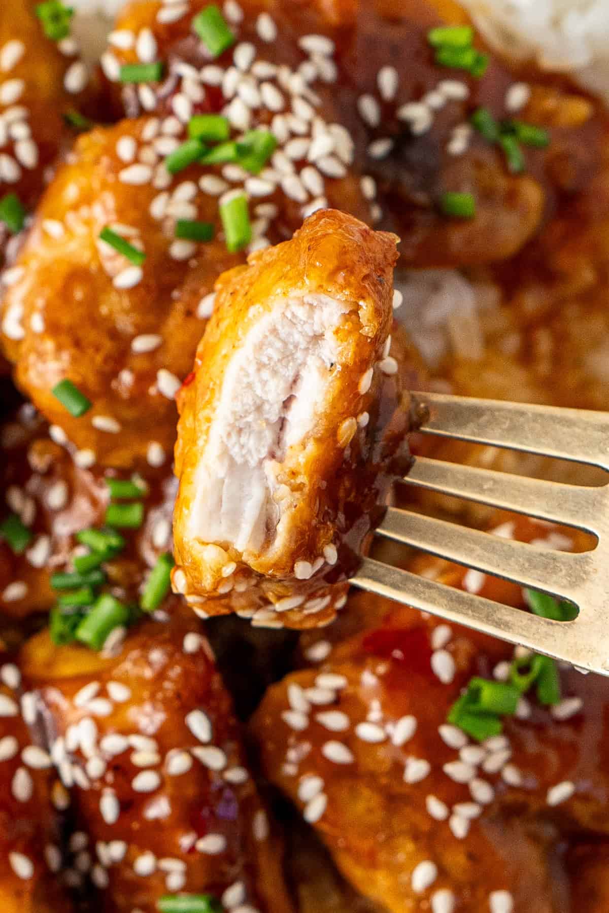 Close up of a piece of chicken with a bite taken.