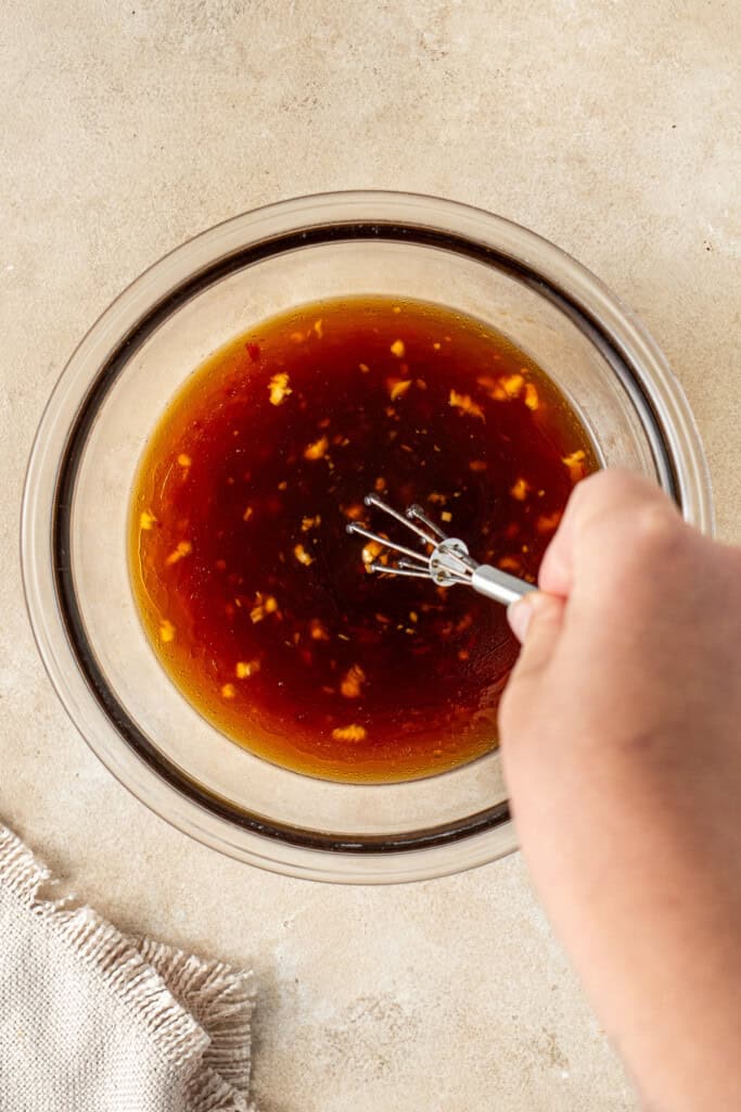 Whisking together the sauce ingredients.