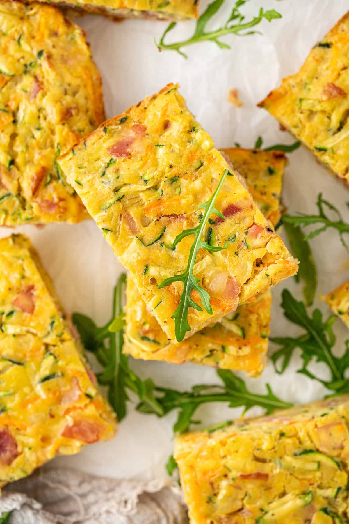 Slices of zucchini slice with bacon.