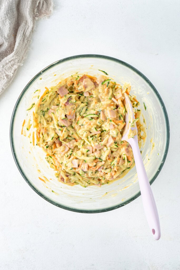 Mixing together the zucchini slice batter.