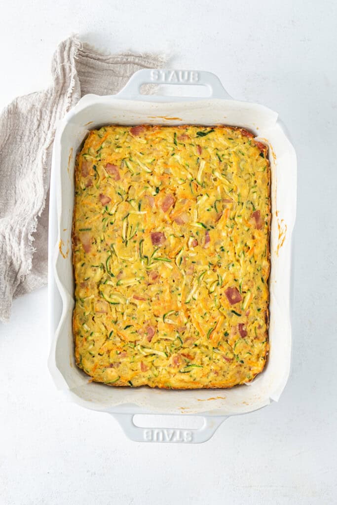 The baked zucchini slice in a baking dish.