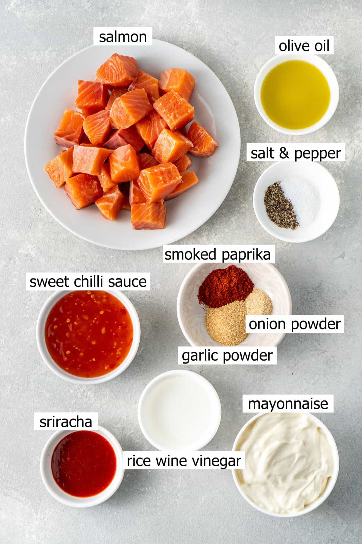 All ingredients needed to make bang bang salmon laid out in small bowls.