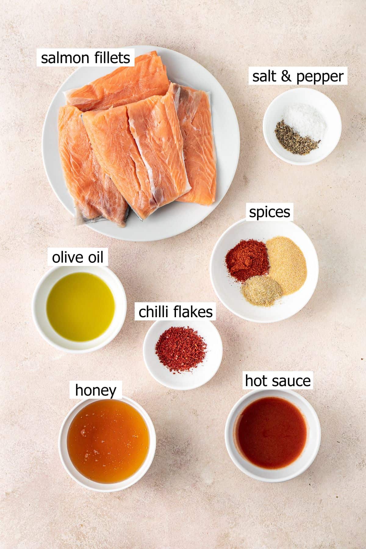 All ingredients needed to make hot honey salmon laid out in small bowls.