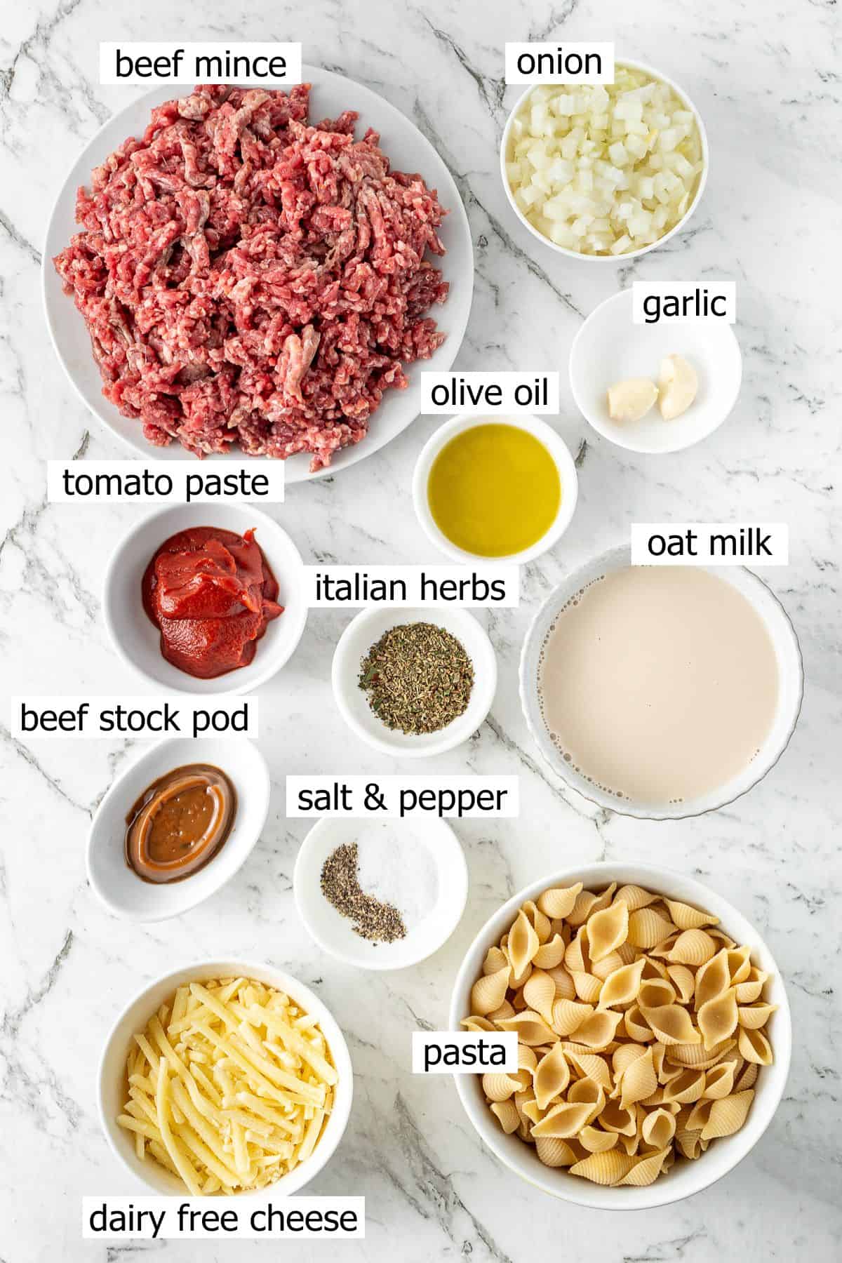 All ingredients needed to make one pot beef mince pasta laid out in small bowls.