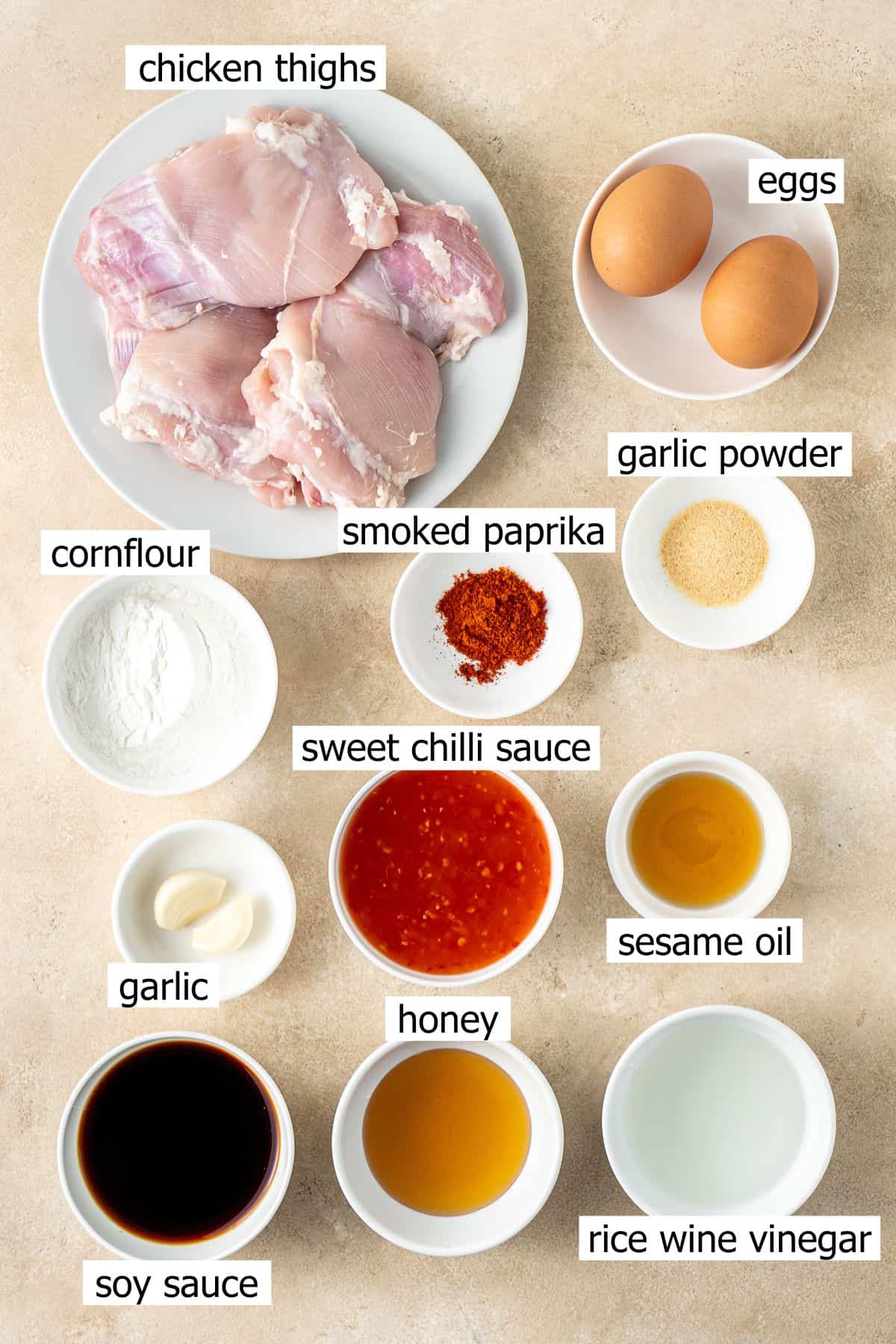 All ingredients needed to make sweet chilli chicken laid out in small bowls.