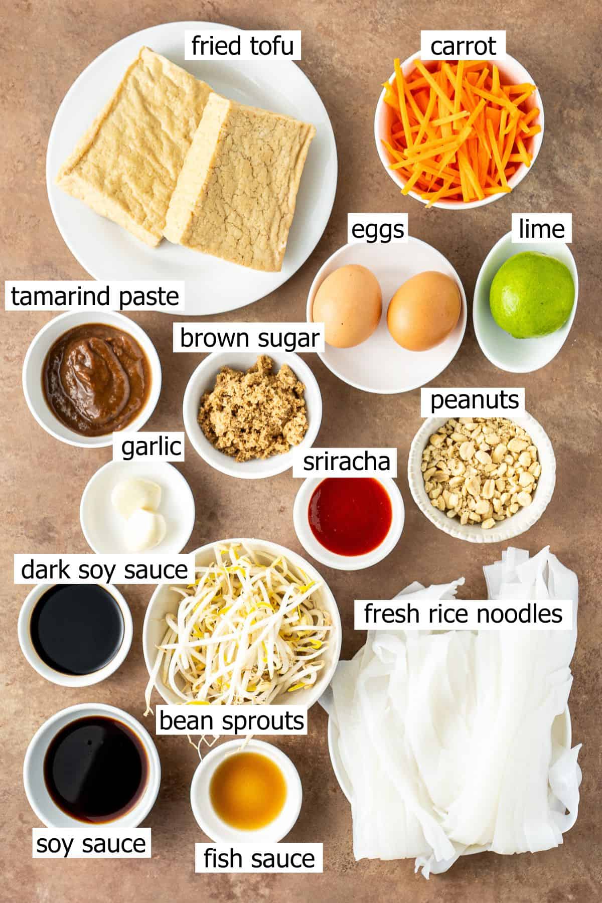 All ingredients needed to make tofu pad Thai laid out in small bowls.