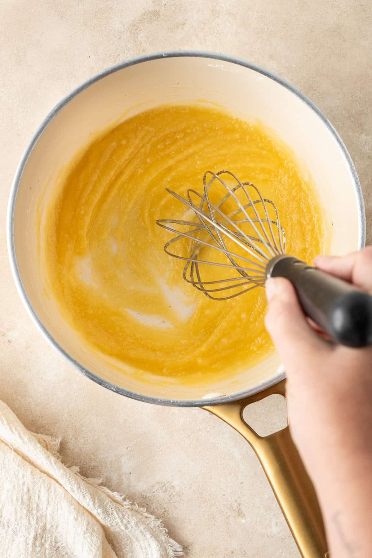 Whisking the dairy free butter and flour together in a saucepan.
