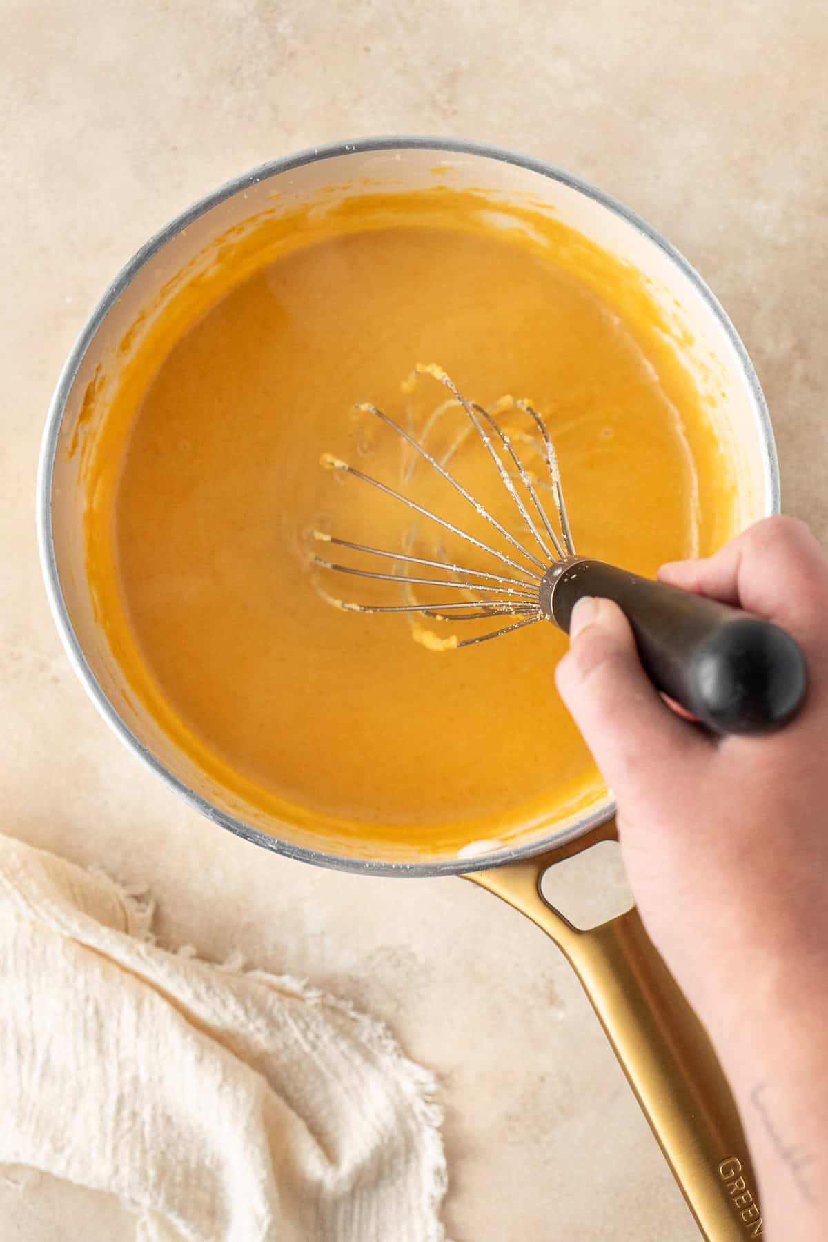 The mac and cheese sauce in a saucepan. 