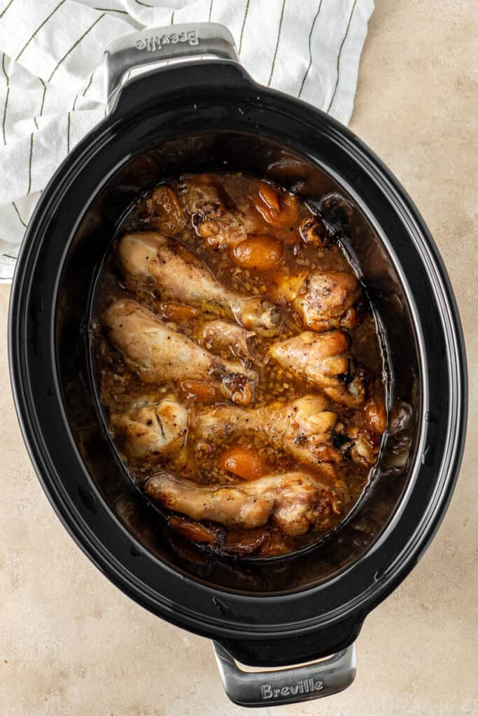 The cooked apricot chicken in the slow cooker.
