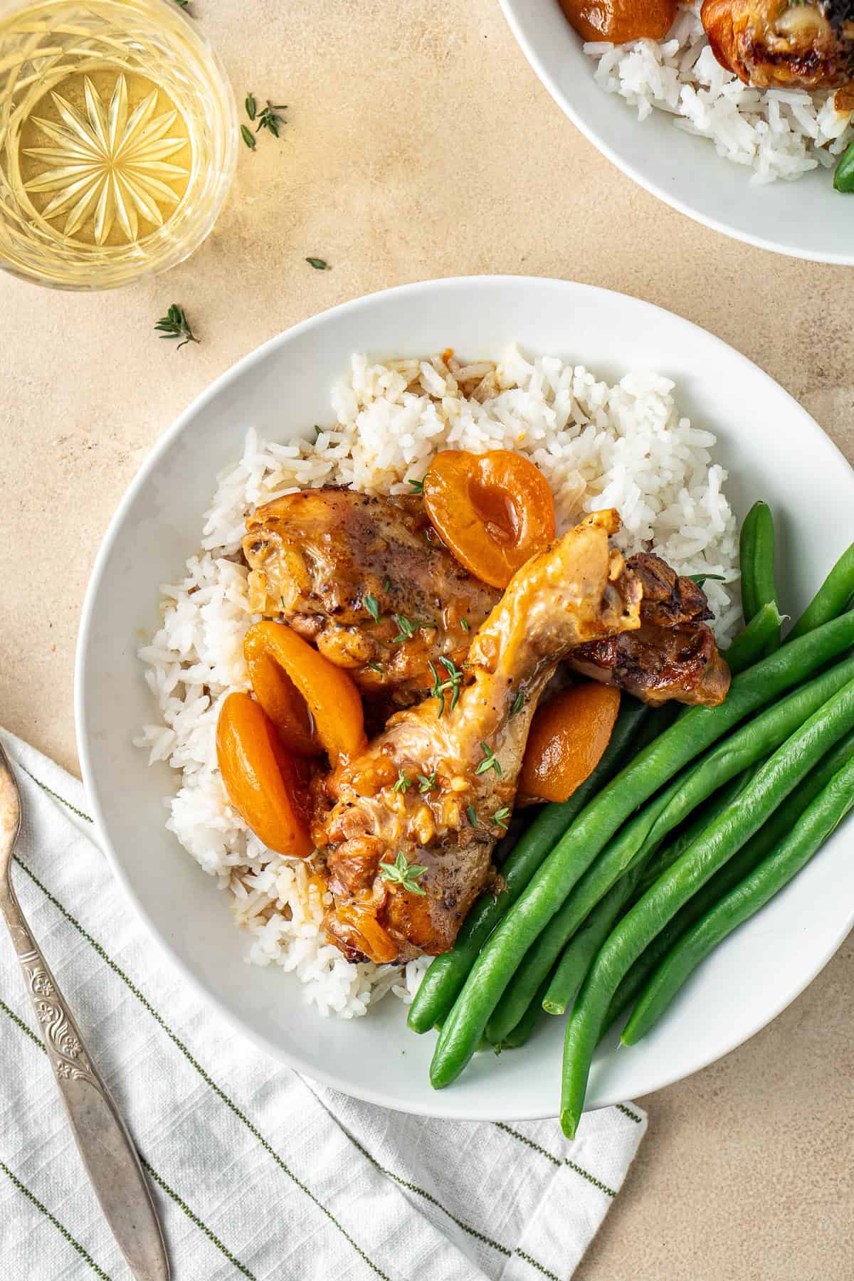 Slow cooker apricot chicken served with rice and green beans.