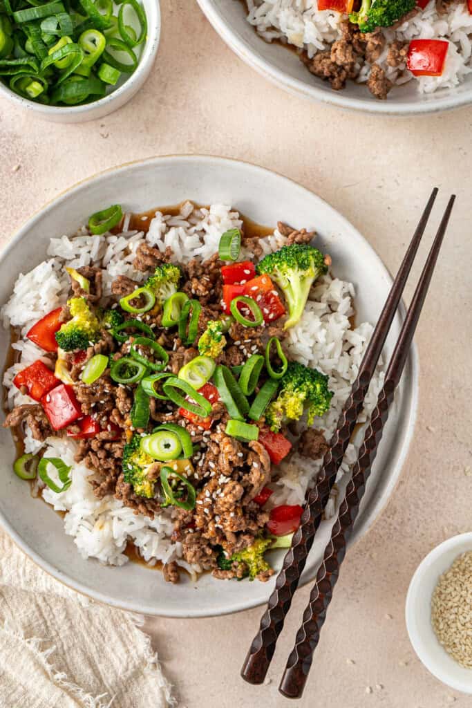 The teriyaki beef bowl served up with garnish and chopsticks.