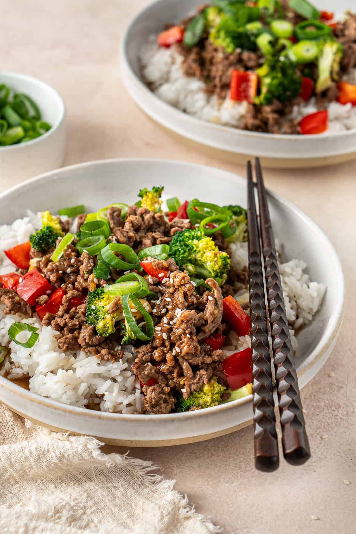 The teriyaki beef bowl with rice and chopsticks.