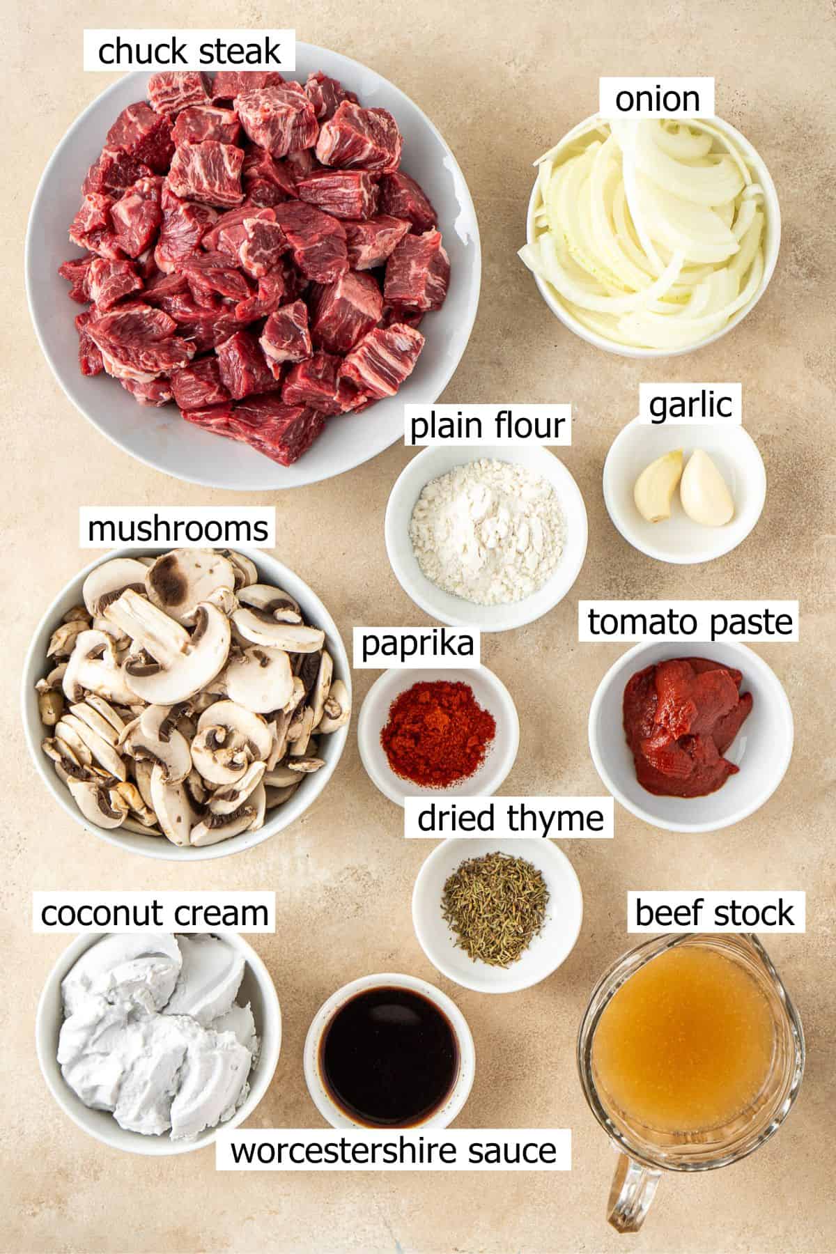 All ingredients needed to make slow cooker beef stroganoff laid out in bowls.