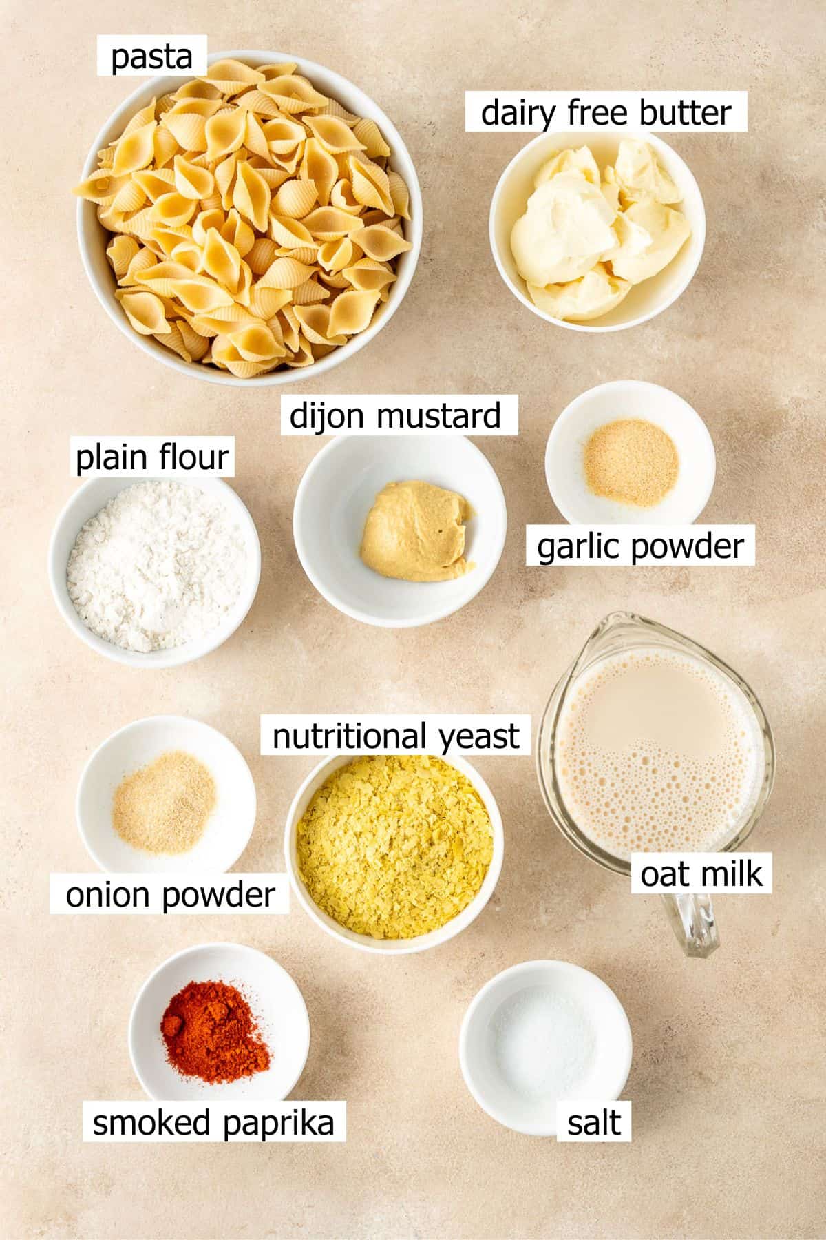 All ingredients needed to make dairy free mac and cheese laid out in bowls.