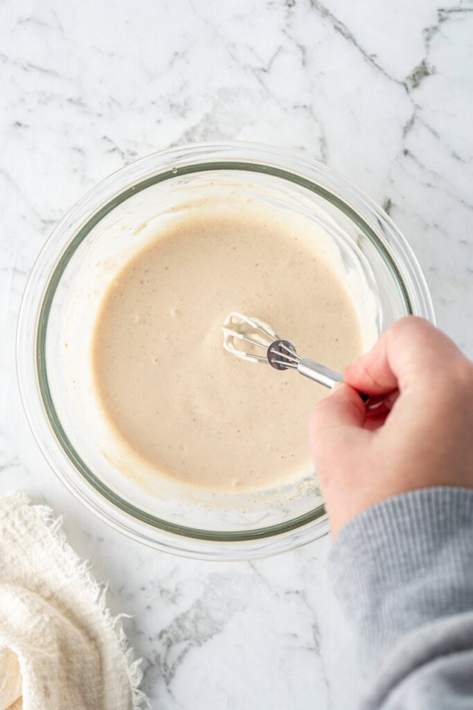 Mixing up the sauce in a small glass bowl.