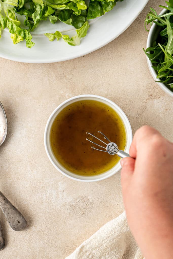 The dressing mixed together with a small whisk.