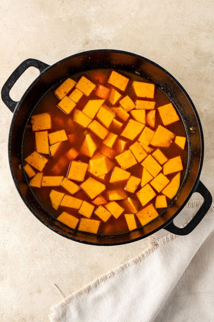 The vegetables and stock added to the pot.