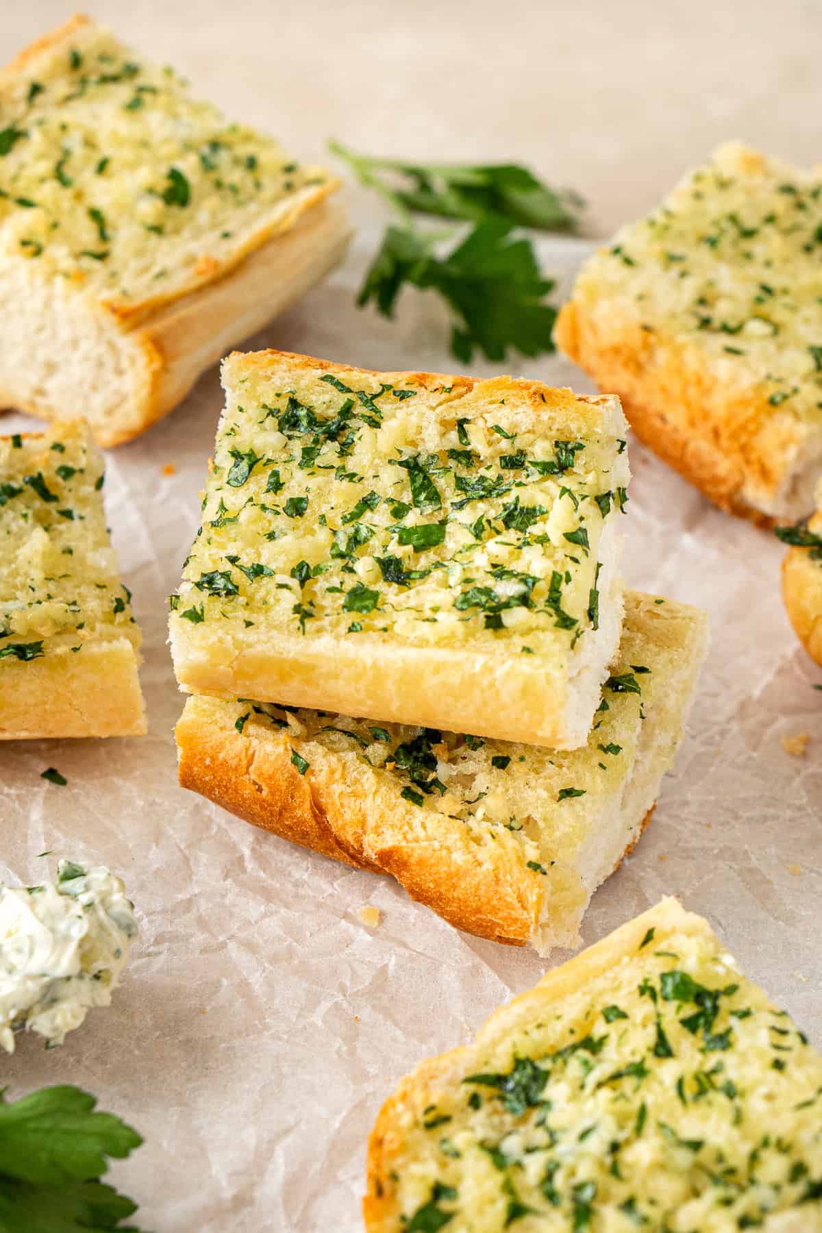 Slices of vegan garlic bread staked on top of each other.