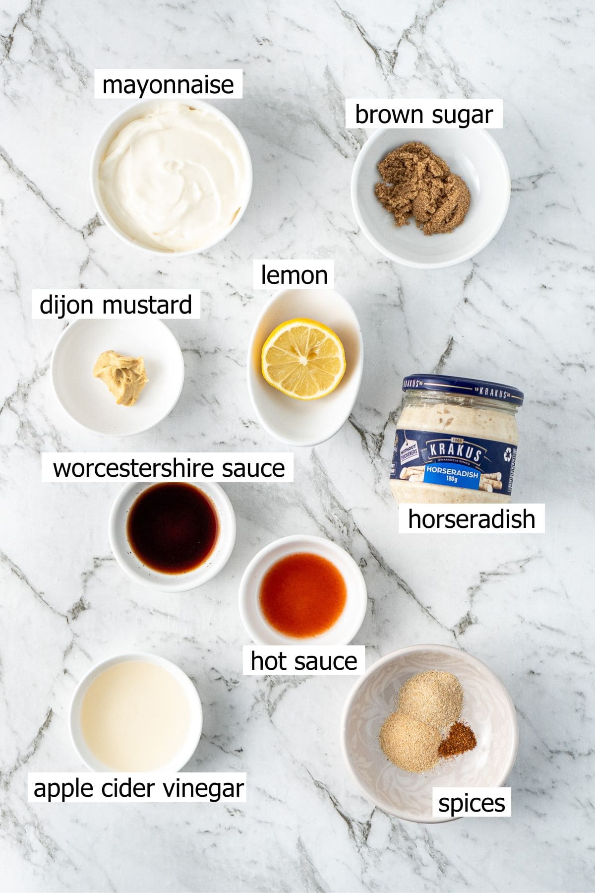 All ingredients needed to make the white sauce laid out in small bowls.