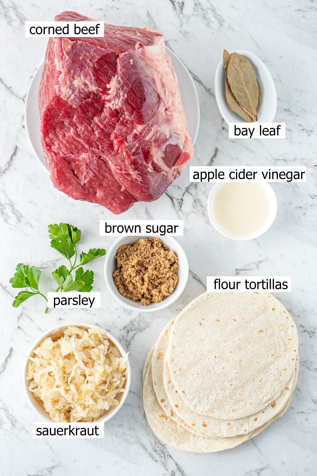 All ingredients needed for corned beef tacos laid out in small bowls.