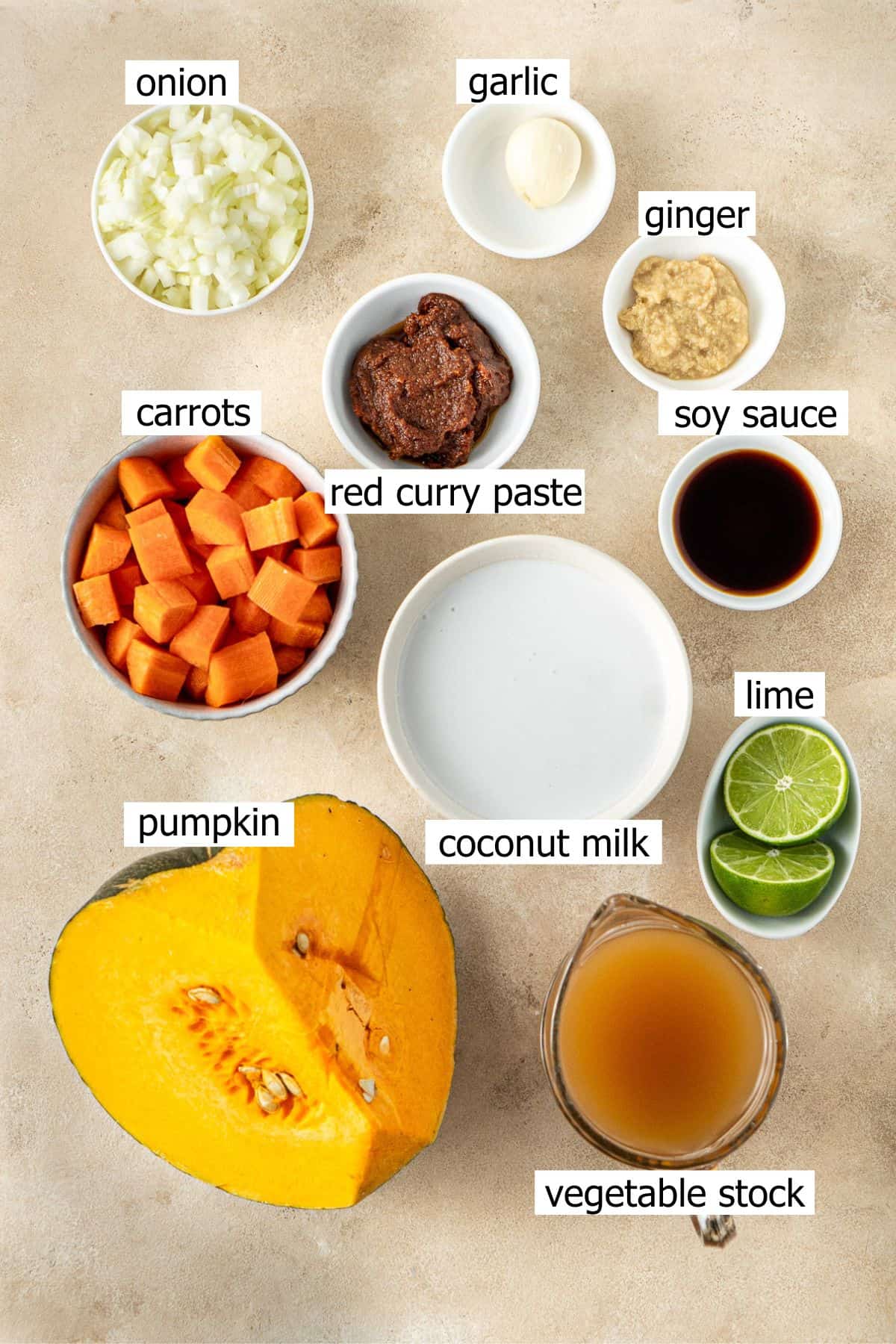 All ingredients needed to make thai coconut pumpkin soup laid out in bowls.