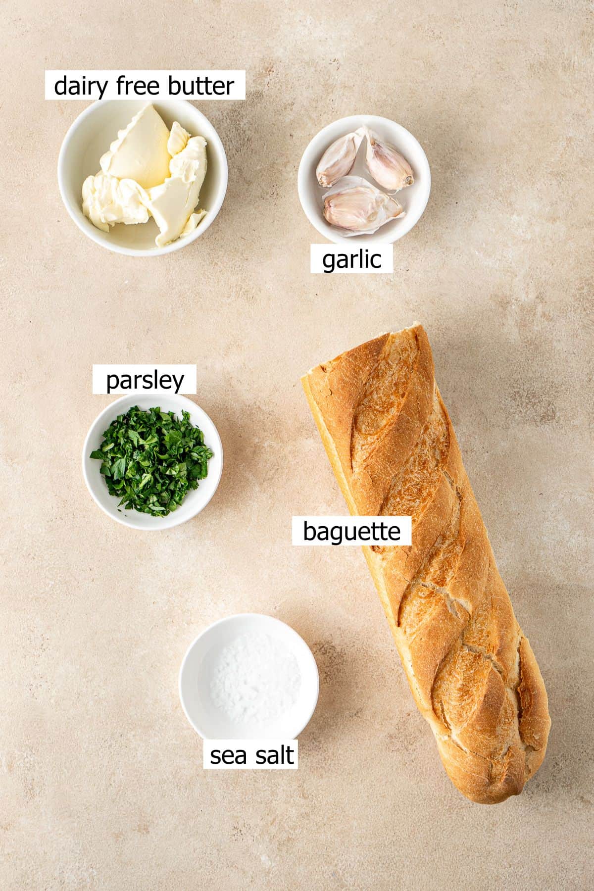 All ingredients needed to make vegan garlic bread laid out.