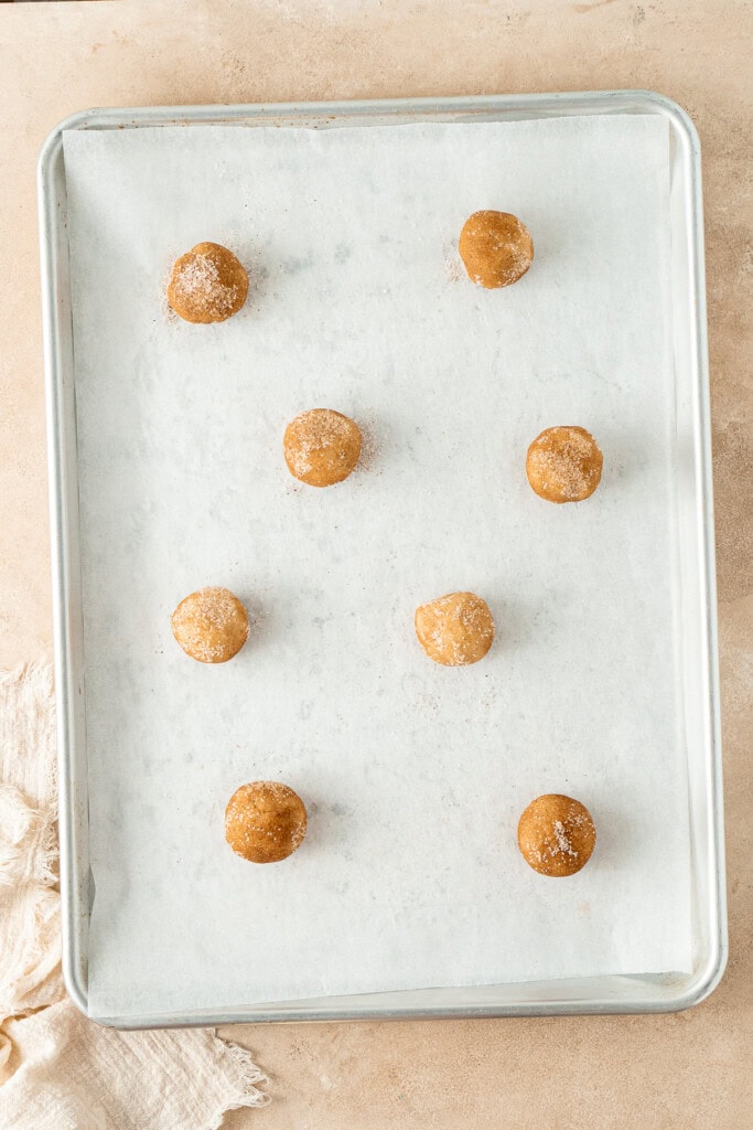 The cookie dough balls on the baking sheet.