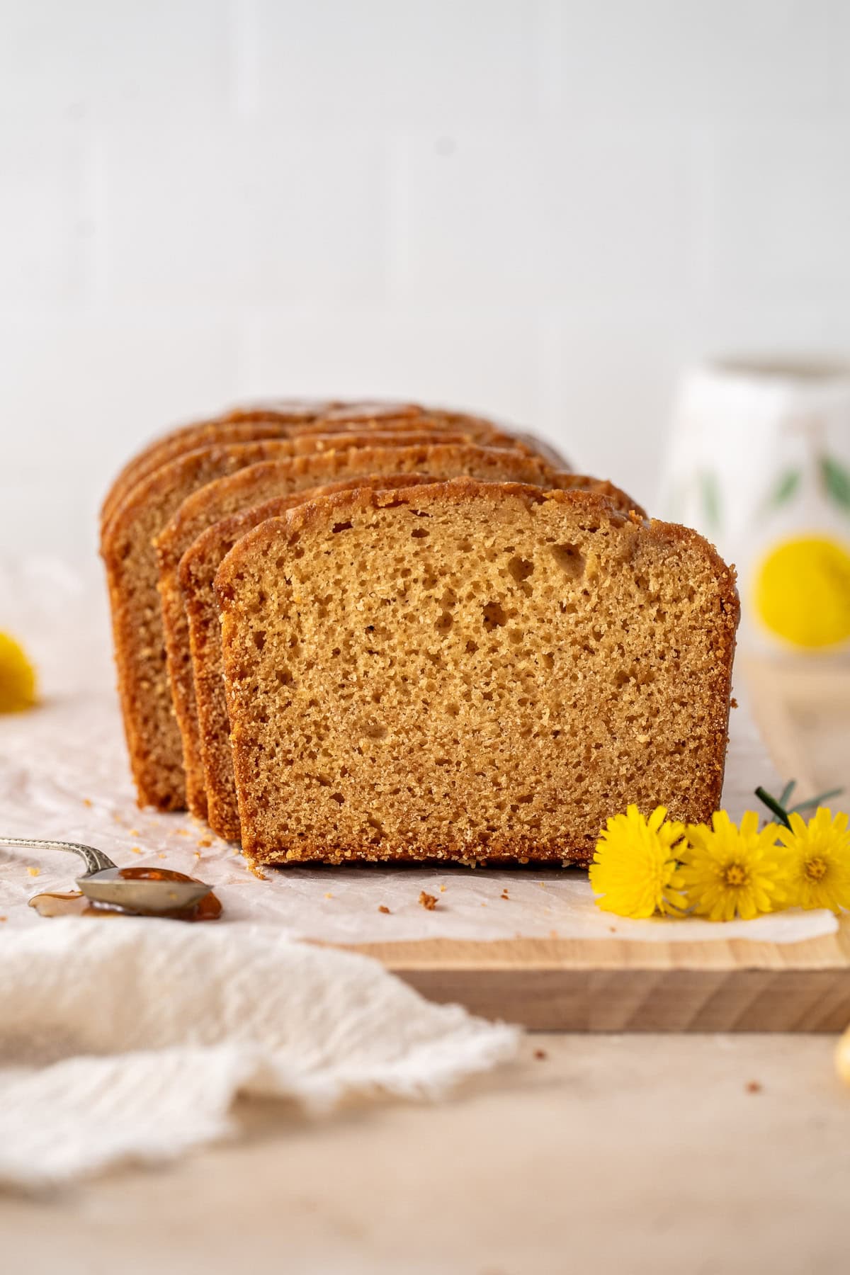 Slices of golden syrup cake sliced with fresh flowers.