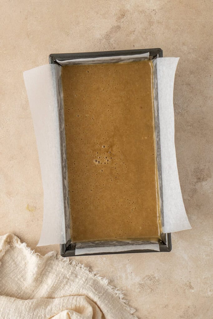 The cake batter in the prepared loaf tin.