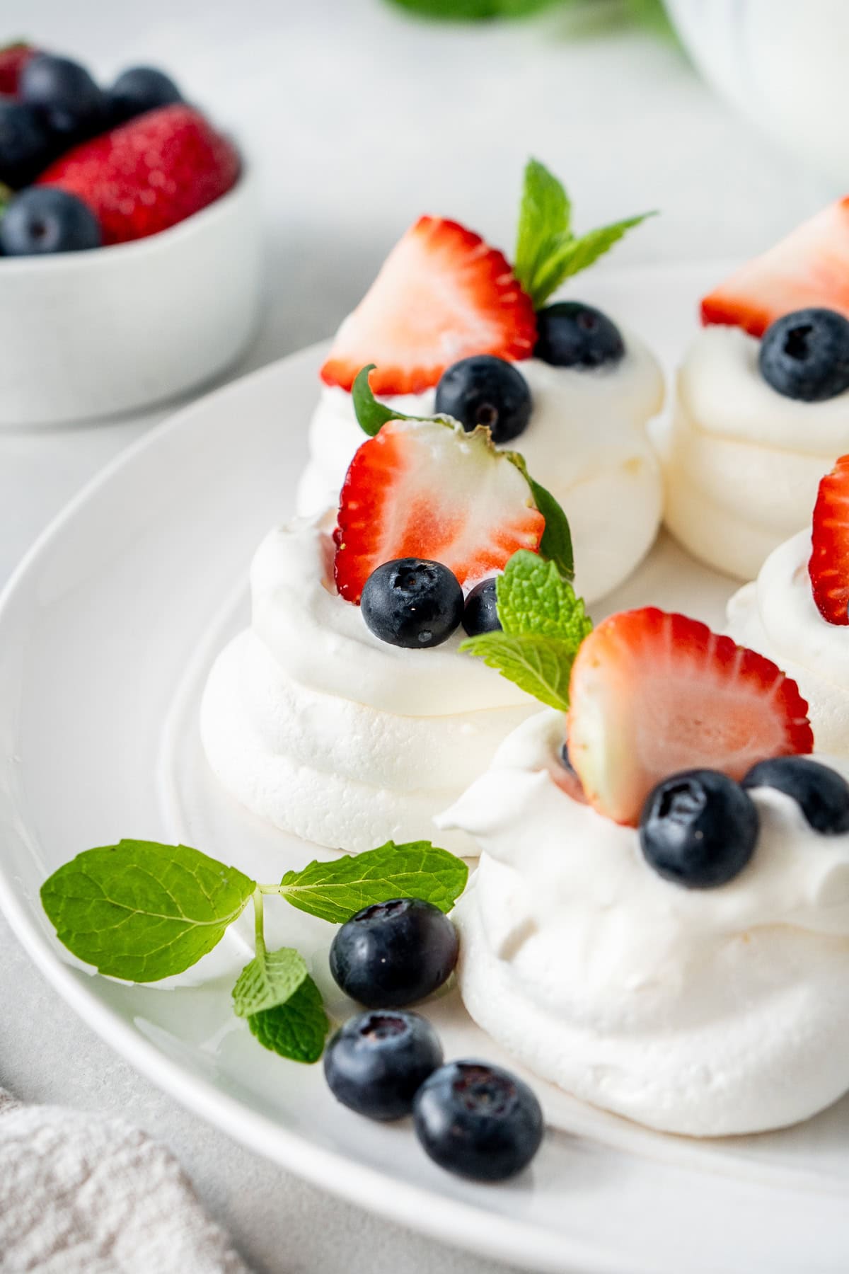 The mini pavlovas on a plate.
