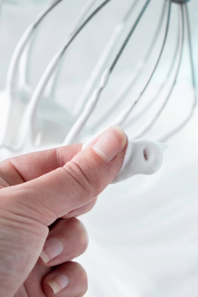 Rubbing the mixture between two fingers.