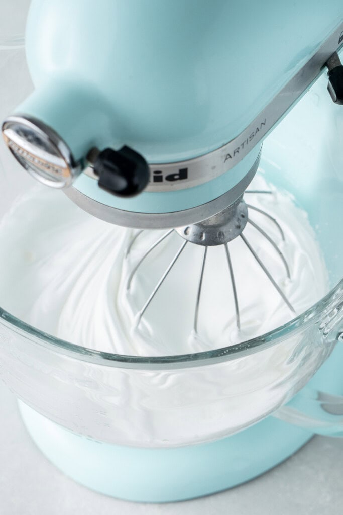 The glossy meringue mixture in the stand mixer.