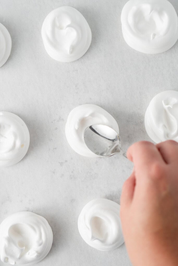 Spooning the mixture onto a baking tray.