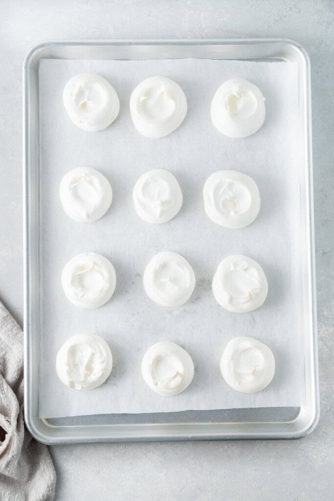 The meringues on a baking tray.