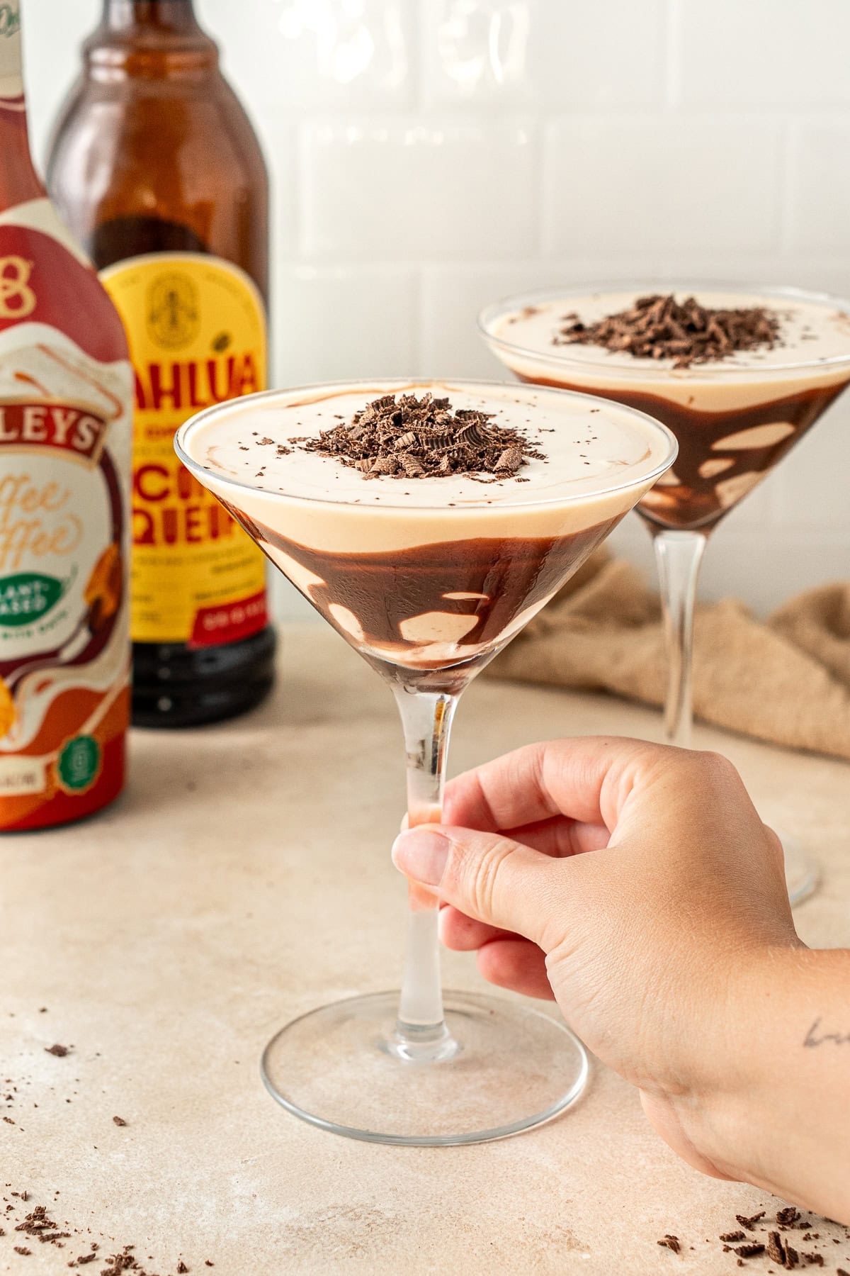 A hand grabbing a mudslide cocktail with chocolate.