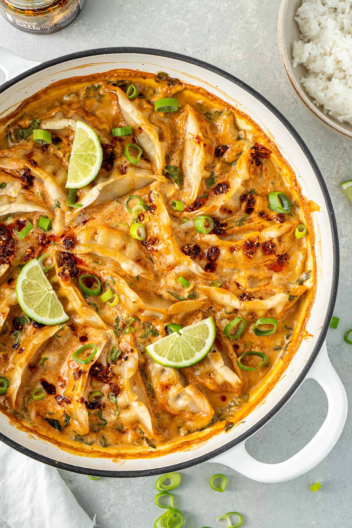 One pan dumpling bake with lime, spring onion and chilli oil.