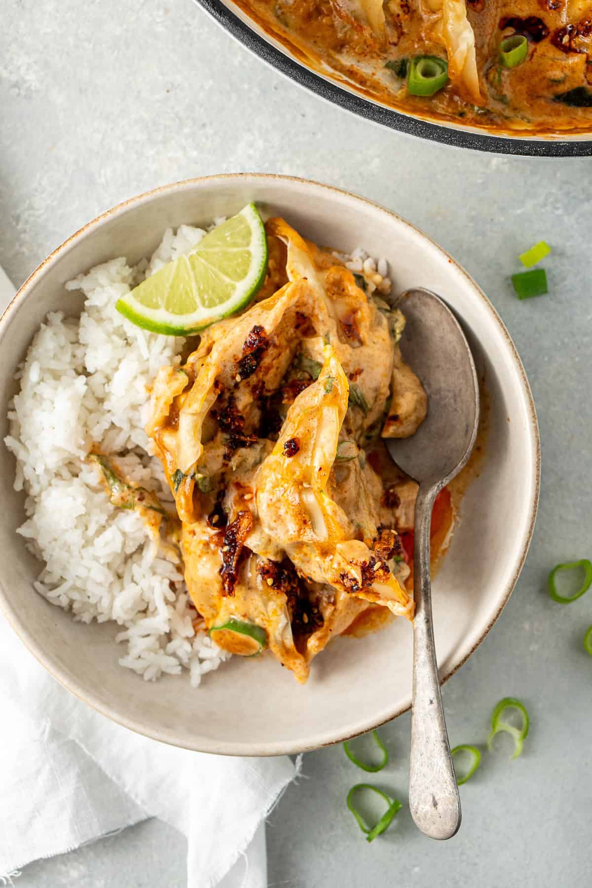 The baked dumplings served in a bowl with rice and a spoon.