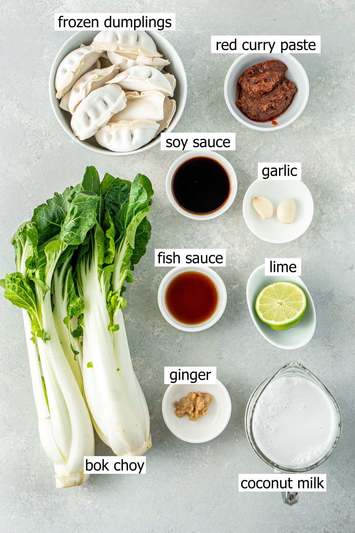 All ingredients needed to make a dumpling bake laid out in small bowls.
