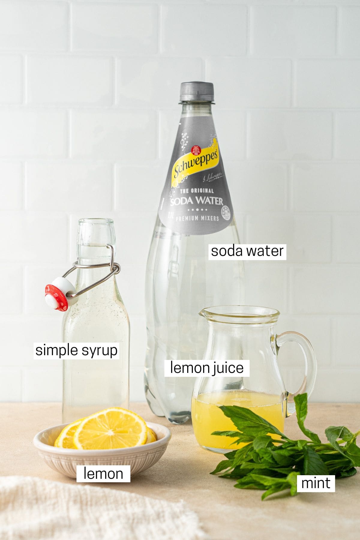 All ingredients needed to make a lemon spritz mocktail.
